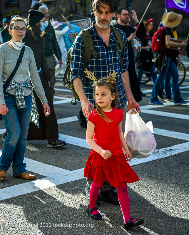 child and father march in earth day parade by xr